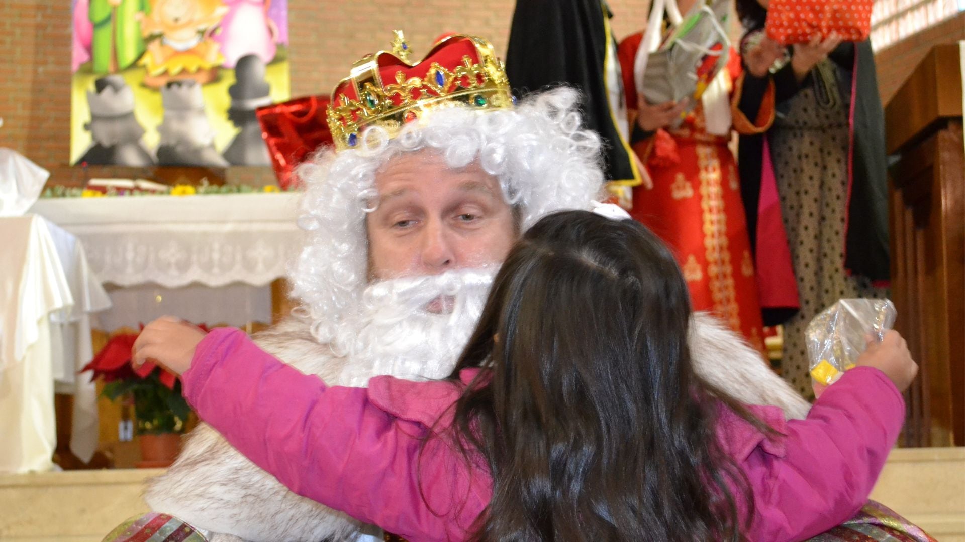 Una niña recibiendo un regalo de los Reyes Magos (Reyes Magos de Verdad)