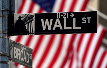 FILE PHOTO: A Wall Street sign is pictured outside the New York Stock Exchange amid the coronavirus disease (COVID-19) pandemic in the Manhattan borough of New York City, New York, U.S., April 16, 2021. REUTERS/Carlo Allegri/File Photo