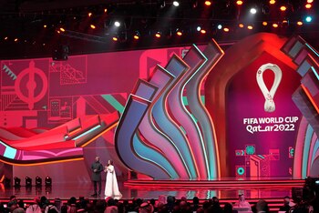 Actor Idris Elba, left, and sports broadcaster Reshmin Chowdhury arrive on stage to host the 2022 soccer World Cup draw at the Doha Exhibition and Convention Center in Doha, Qatar, Friday, April 1, 2022. (AP Photo/Darko Bandic)