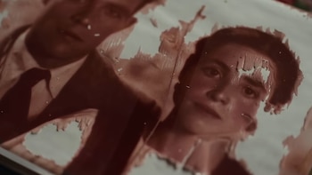 Retrato fotográfico antiguo y con rasgaduras que muestra el rostro de un hombre con traje y a una mujer joven