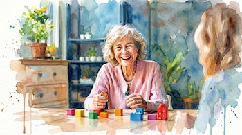 Ilustración en acuarela de una mujer mayor de cabello blanco y suéter rosa, riendo mientras sostiene un bloque de madera. Hay bloques de colores sobre la mesa.