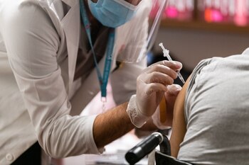 A pharmacist administers a dose