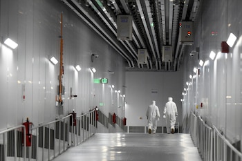 Las cápsulas unificadas de apertura frontal, también conocidas como FOUP, transportan obleas de silicona sobre la pasarela hasta la Fase III en GlobalFoundries Fab 8. CRÉDITO: Foto para The Washington Post por Cindy Schultz