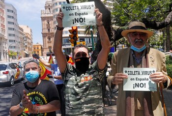 Demonstrators watch a drive-in protest