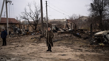 A woman stands amid the destruction caused by the war in Bucha, in the outskirts of Kyiv, Ukraine, Tuesday, April 5, 2022. Ukraine's president planned to address the U.N.'s most powerful body on Tuesday after even more grisly evidence emerged of civilian massacres in areas that Russian forces recently withdrew from. (AP Photo/Rodrigo Abd)