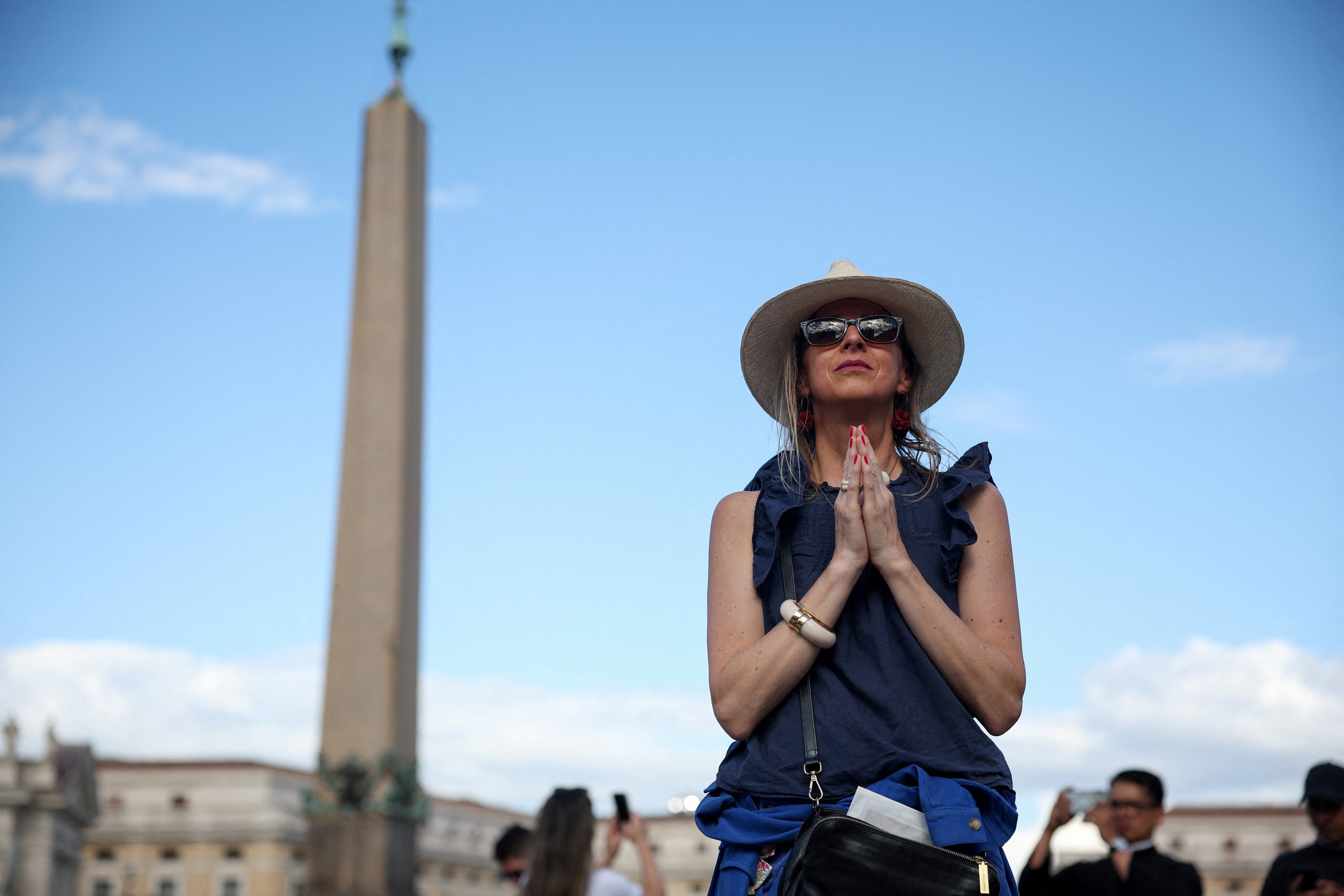 A woman prays at St. Peter