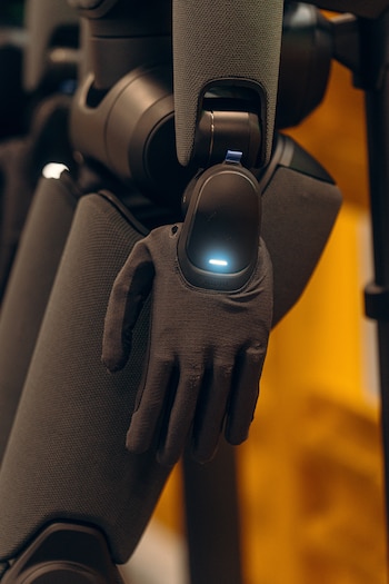 A humanoid robot with hands covered in soft gloves, to better mimic human hands, at the BMW manufacturing plant in Spartanburg, S.C. on June 30, 2026. Carmakers have used robots for decades, but they are usually powerful, one-armed machines that are fixed in place and perform repetitive tasks. Now, most major automakers are betting that humanoid robots can usher in a new wave of automation. (Will Crooks/The New York Times)