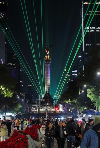 Lights are projected from behind the Angel of Independence during the Polymarchs sound concert to celebrate the New Year in Mexico City, Mexico January 1, 2025. REUTERS/Henry Romero