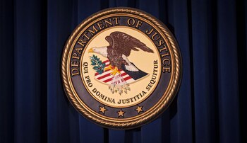 FILE PHOTO: The Department of Justice (DOJ) logo is pictured on a wall after a news conference to discuss alleged fraud by Russian Diplomats in New York December 5, 2013. REUTERS/Carlo Allegri/File Photo
