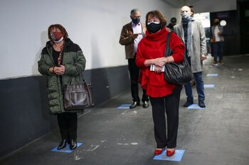 People line up while maintaining