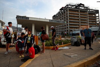 People wait outside an hotel