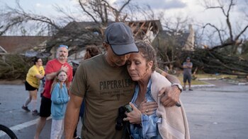 Michael Talamantez comforts his girlfriend Derry Schroer after Talamantez' house on Stratford Drive in Round Rock, Texas was destroyed by a severe storm, reported as a tornado, while they were inside on Monday March 21, 2022. "I thought I was going to die," he said. (Jay Janner/Austin American-Statesman via AP)