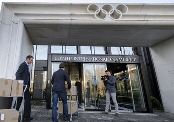 Staff carry the bid files