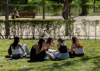 Un grupo de personas sentadas en el césped de un parque, a 17 de marzo de 2026, en Madrid (España). (Eduardo Parra/Europa Press)