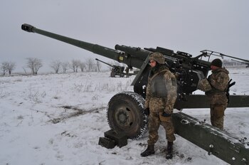 Ukrainian service members operate 2A65 Msta-B howitzers during artillery and anti-aircraft drills near the border with Russian-annexed Crimea in the Kherson region, Ukraine, in this handout picture released January 28, 2022. Press Service of the Joint Forces Operation/Handout via REUTERS ATTENTION EDITORS - THIS IMAGE HAS BEEN SUPPLIED BY A THIRD PARTY.
