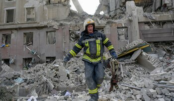 A firefighter clears the rubble