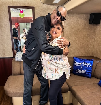 El rapero estadounidense Snoop Dogg y la vocalista salvadoreña "Nory" Flores comparten un abrazo. (Cortesía: Los Hermanos Flores Orquesta Internacional)