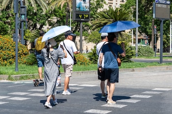 Imágenes de personas al lado de un termómetro en las calles de la capital hispalense a 47 grados de temperatura, a 24 de julio de 2024, en Sevilla, Andalucía (España). (Francisco J. Olmo/Europa Press)
