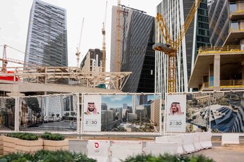 Portraits of Mohammed bin Salman and King Salman at a construction site in the King Abdullah Financial District in Riyadh. Photographer: Tasneem Alsultan/Bloomberg