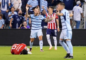 Jul 31, 2023; Kansas City, KS, USA; Sporting Kansas City forward Johnny Russell (7) reacts after a foul on Chivas Guadalajara forward Alexis Vega (10) during the first half against Chivas Guadalajara at Children's Mercy Park. Mandatory Credit: Jay Biggerstaff-USA TODAY Sports