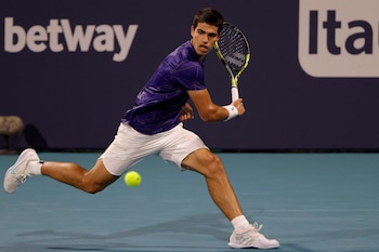 Mar 29, 2022; Miami Gardens, FL, USA; Carlos Alcaraz (ESP) hits a backhand against Stefanos Tsitsipas (GRE)(not pictured) in a men's fourth round men's singles match in the Miami Open at Hard Rock Stadium. Mandatory Credit: Geoff Burke-USA TODAY Sports
