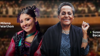 Dos mujeres, Milena Warthon y Susana Baca, sonríen. Warthon tiene trenzas, detalles morados y aretes de corazón. Baca viste chal oscuro y joyas plateadas