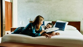 Smiling couple relaxing on bed