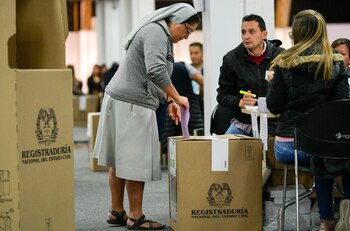 A nun casts her vote
