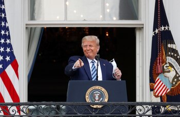 U.S. President Donald Trump gestures as he stands on a White House balcony speaking to supporters gathered on the South Lawn for a campaign rally that the White House is calling a "peaceful protest" in Washington, U.S., October 10, 2020. REUTERS/Tom Brenner