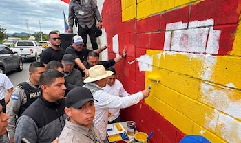 Álvaro Uribe tapando mural frente a su residencia