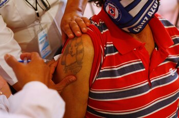 An elderly man receives the