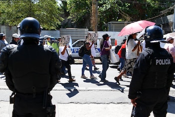 Police officers stand guard, as