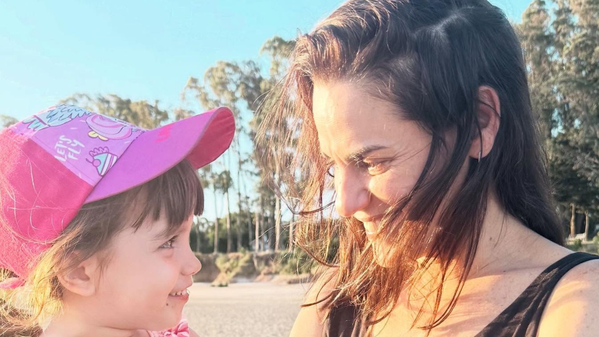 Pilar Gamboa y su hija Ana, de cuatro años, se miran sonrientes bajo el sol en un exterior, celebrando el cumpleaños de la menor.