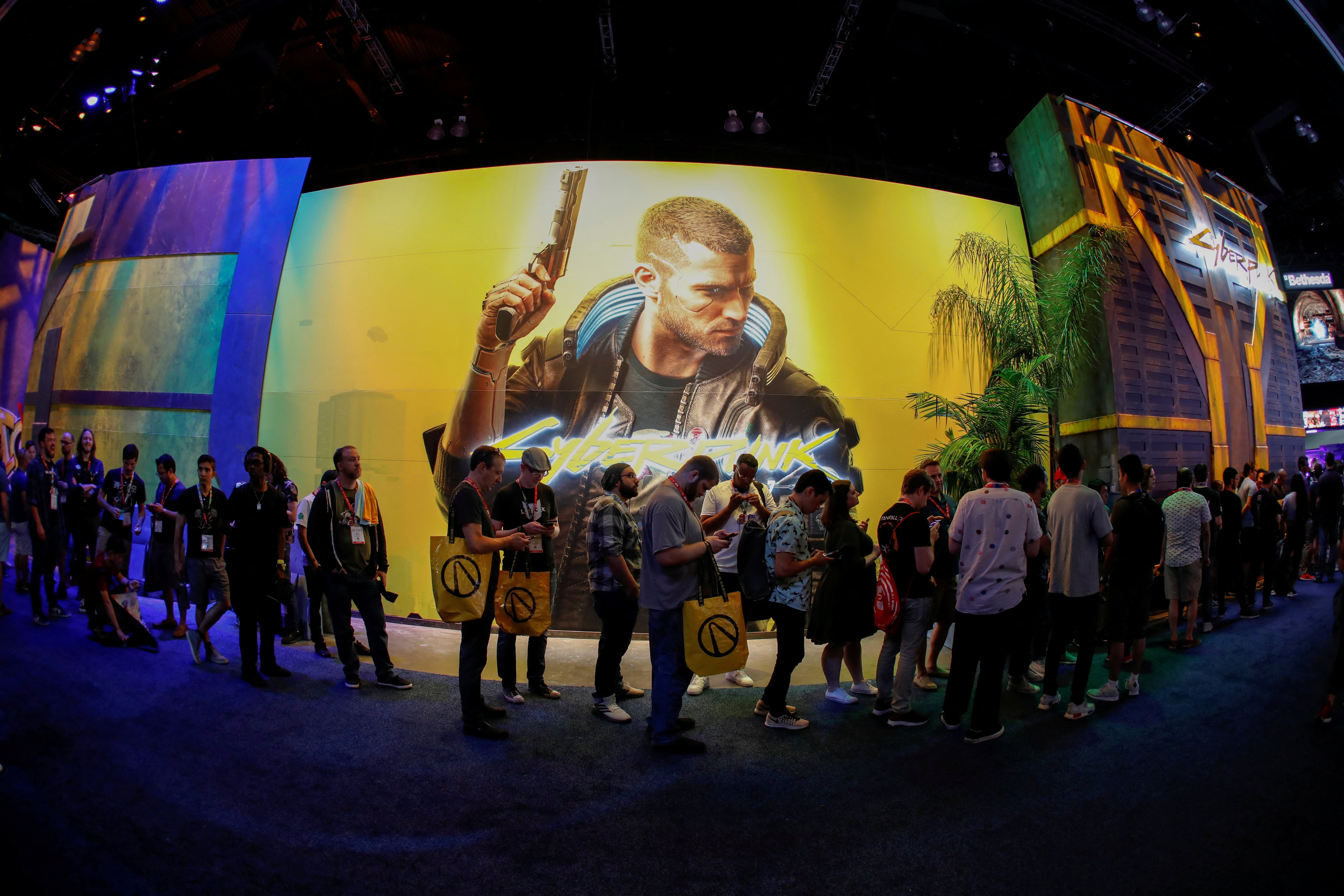 FILE PHOTO: Attendees wait in line at the Cyberpunk 2077 booth during the opening day of E3, the annual video games expo revealing the latest in gaming software and hardware in Los Angeles, California, U.S., June 11, 2019. REUTERS/Mike Blake/File Photo