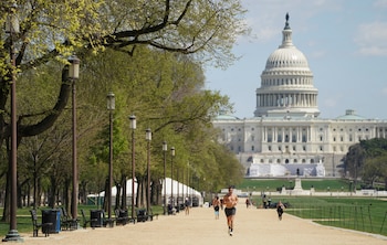 Despite coronavirus health measures which have shut down most of the city, people jog and walk along the National Mall in Washington , U.S., April 2, 2020. REUTERS/Kevin Lamarque