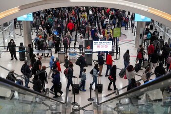 FILE PHOTO: Travelers form lines
