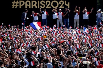 People gather at Paris' Olympics fan zone to watch the closing ceremony of the Tokyo games, in front of the Eiffel Tower, at Trocadero Gardens in Paris, France, August 8, 2021. REUTERS/Benoit Tessier