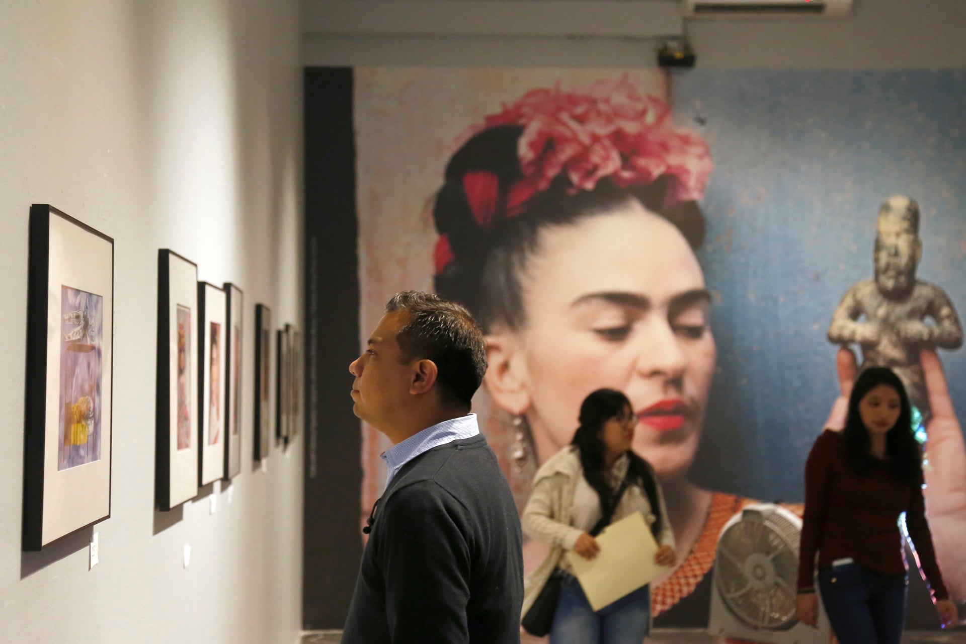 Fotografía del 23 de noviembre de 2018 que muestra a personas observando una exposición de la pintora mexicana Frida Kahlo, en Puebla, México (Foto: EFE/ Francisco Guasco)