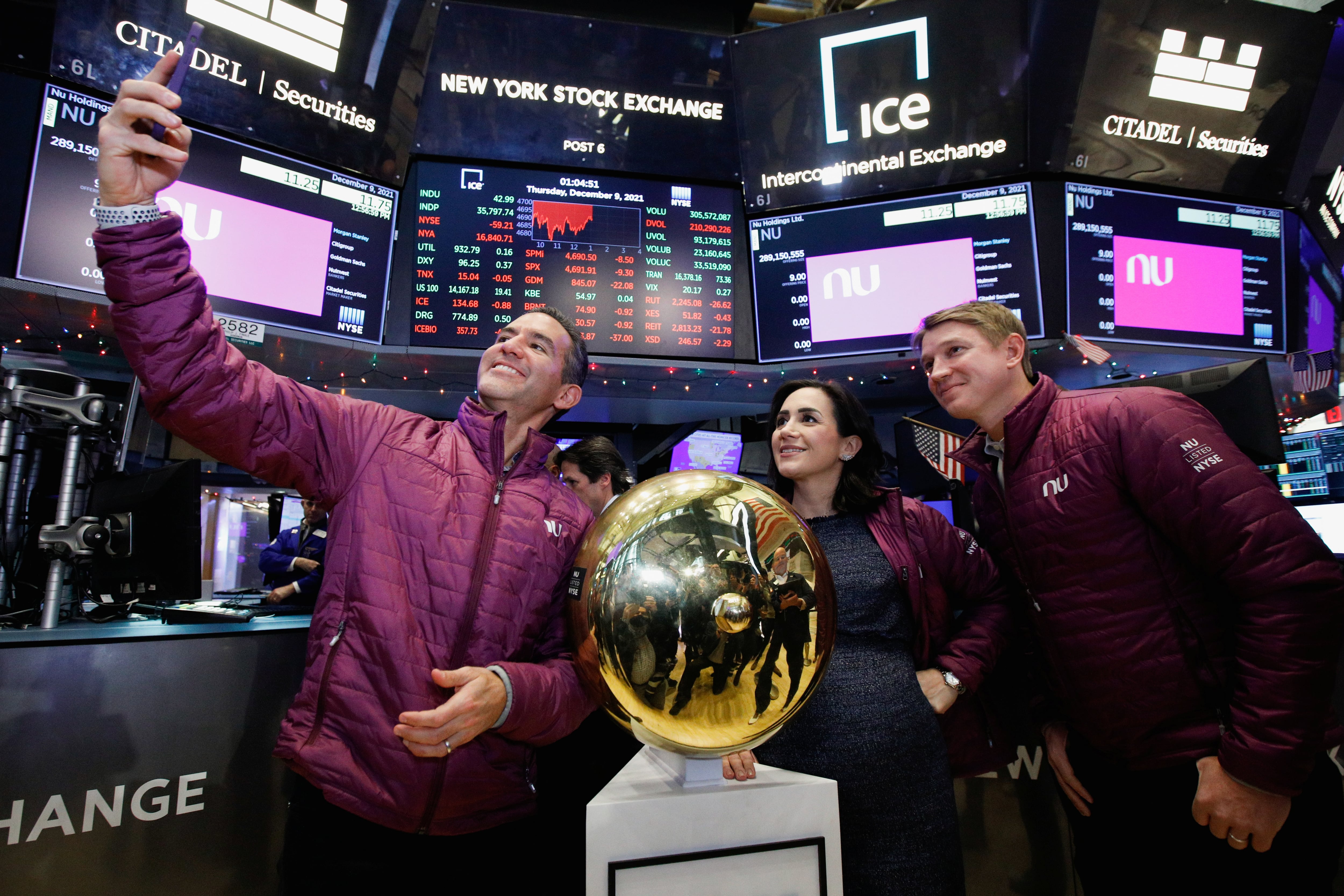 David Velez, Founder and CEO of Nubank, a Brazilian FinTech startup, takes a selfie with co-founders Cristina Junqueira and Edward Wible, as they celebrate the company's first trade during the IPO at the New York Stock Exchange (NYSE) in New York, U.S., December 9, 2021. REUTERS/Brendan McDermid