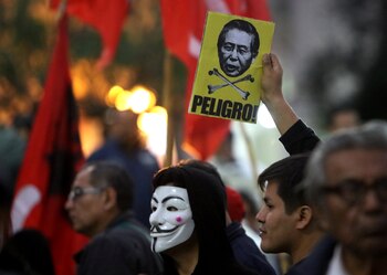A protester holds a sign with an image of former president Alberto Fujimori with the word 'Danger' during a march against a possible pardon for Fujimori, who has been serving a 25-year sentence for human rights violations, in Lima, Peru July 7, 2017. REUTERS/Guadalupe Pardo