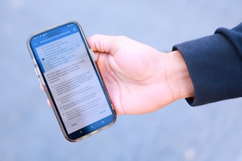 A migrant holds a phone