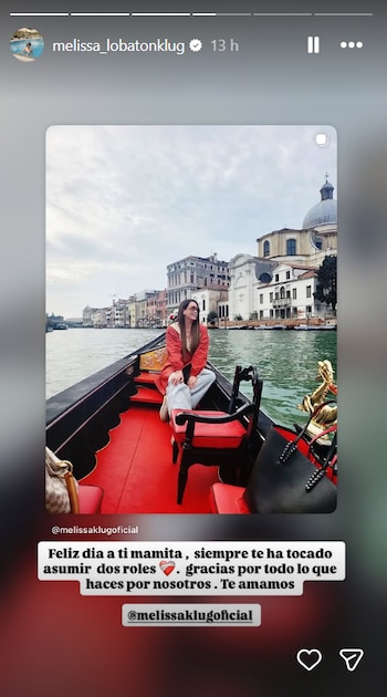 Una mujer en una góndola, vestida con abrigo rojo y gafas de sol, navega por un canal de Venecia rodeado de edificios históricos bajo un cielo nublado. Incluye texto en pantalla