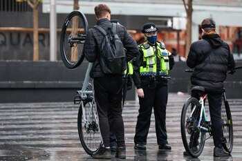 Police officers speaks with cyclists