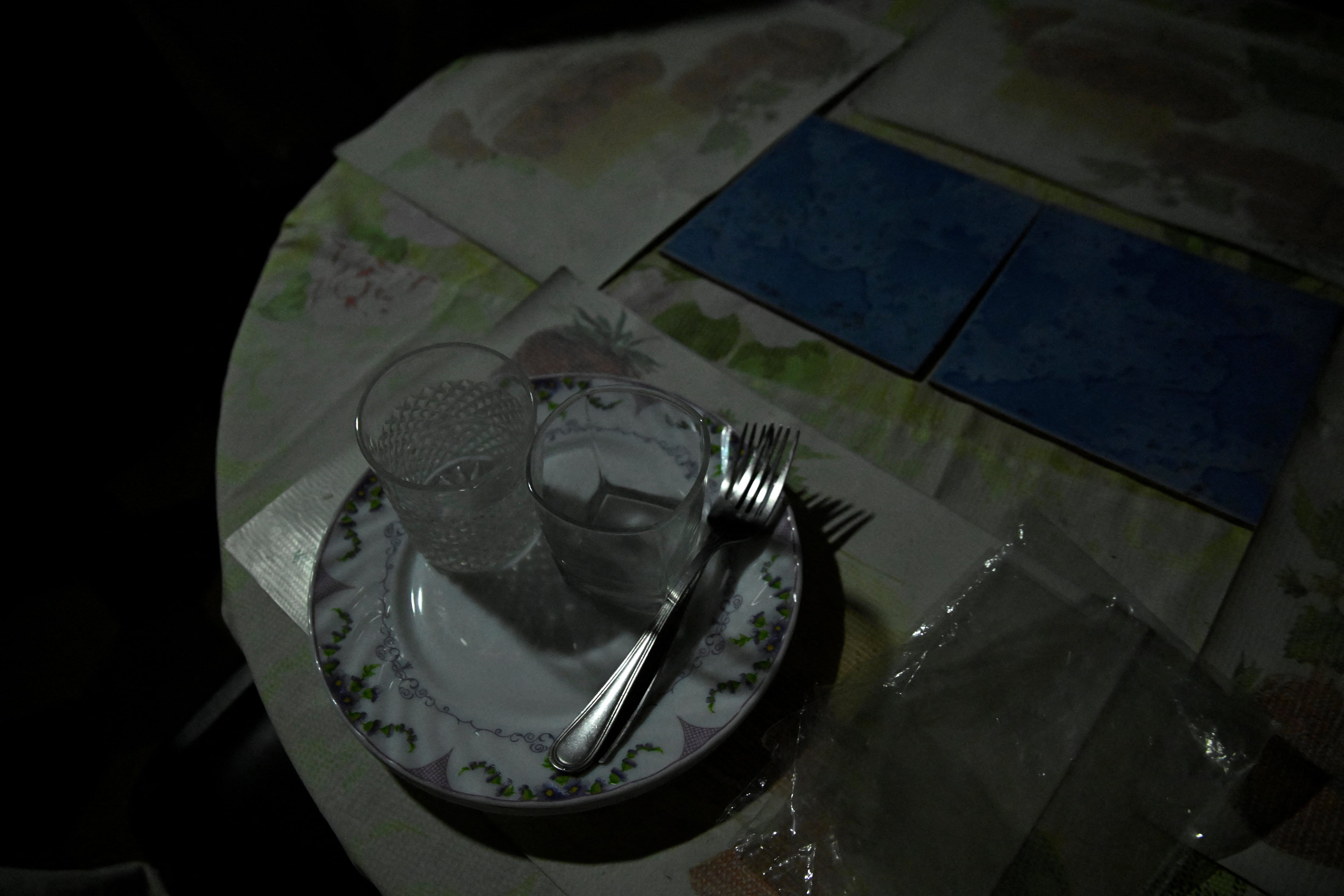 Tableware is placed on a table by Mayra Madariaga, 72, during a blackout in Havana, Cuba, September 2, 2025. Cuba has appealed to the United Nations World Food Programme for support to maintain meals for vulnerable groups.