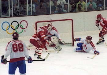 Eric Lindros looks on as
