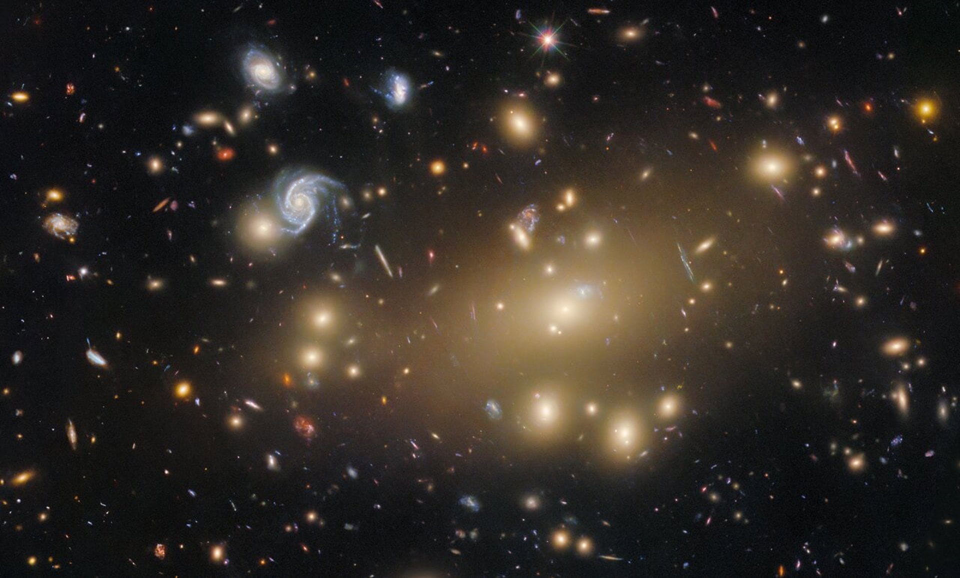 Un enorme cúmulo de galaxias que se expande en el espacio-tiempo, imagen de la semana de Hubble. (ESA/HUBBLE Y NASA, M. POSTMAN, P. KELLY)