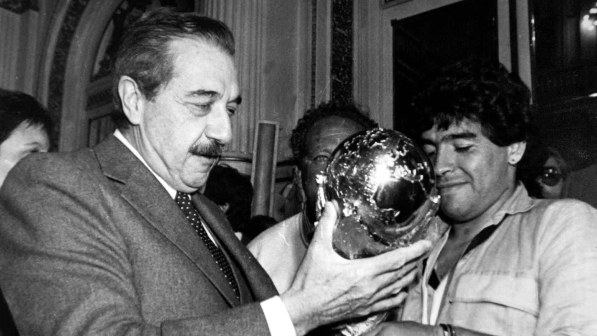 El por entonces presidente Raúl Alfonsín con el trofeo junto a Diego Maradona tras el Mundial 86 (REUTERS)