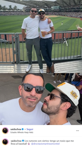Said Ochoa y su novio posan abrazados con gafas de sol en un estadio de béisbol, con el campo verde y las gradas llenas de público al fondo