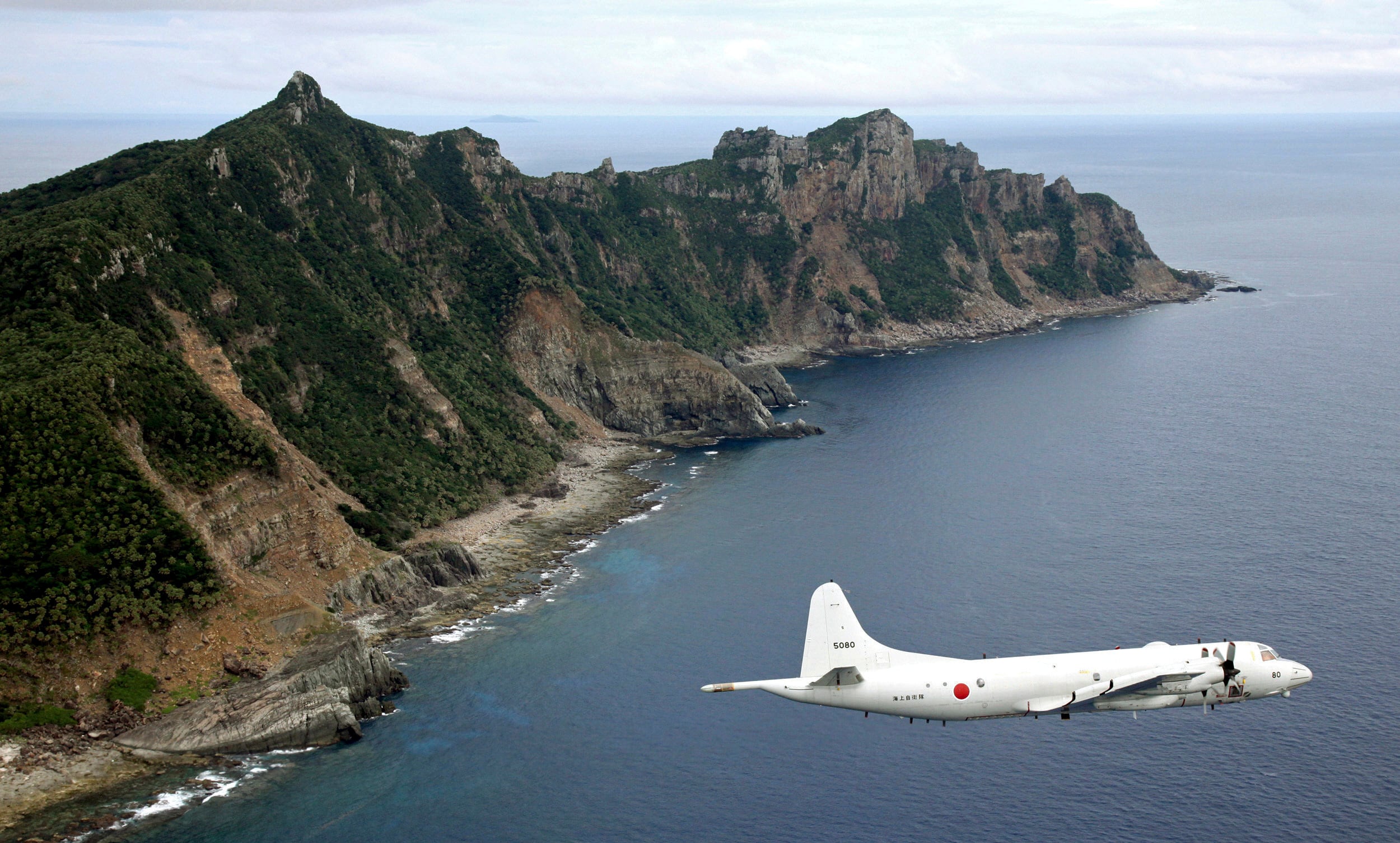 Un avión P-3C Orion de vigilancia de la Fuerza Marítima de Autodefensa de Japón vuela sobre las islas disputadas conocidas como Senkaku, el 13 de octubre de 2011 (AP, Archivo)