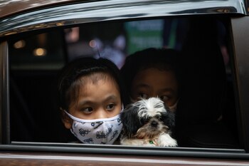 Kids aboard a vehicle hold